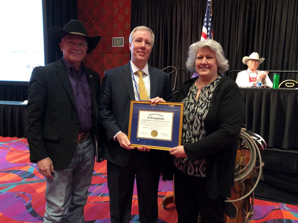 Sheriff Donahue and CCSO employee Debbie McRae receiving award from Mike Cormaci, President of OffenderWatch